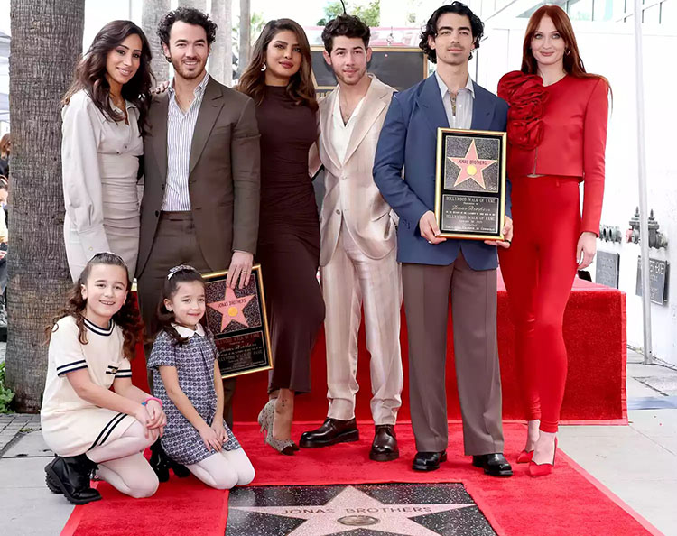 Danielle Jonas, Kevin Jonas, Priyanka Chopra, Nick Jonas, Joe Jonas, Sophie Turner, and (front) Alena Rose Jonas and Valentina Angelina Jonas attend The Hollywood Walk of Fame star ceremony honoring The Jonas Brothers on January 30, 2023 in Hollywood, California. 