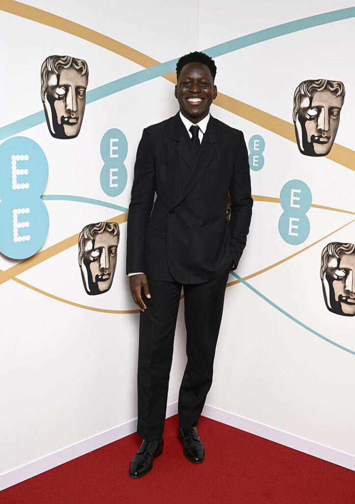 Toheeb Jimoh wore a Dior men’s collection black wool notch lapel oblique suit,

a classic white cotton shirt, a black silk tie and black leather derbies.