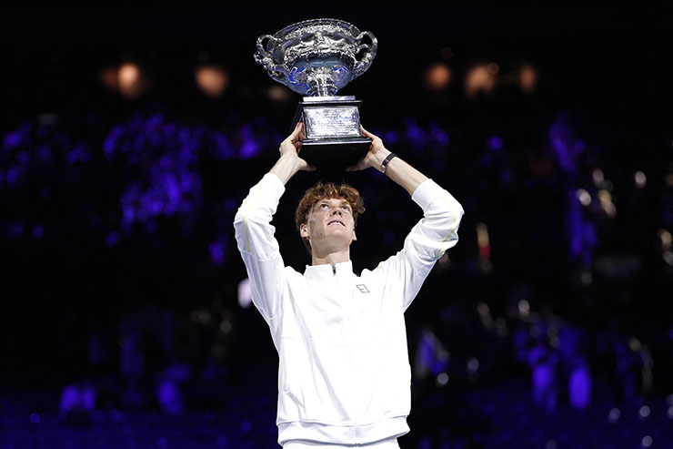 Italy's Jannik Sinner celebrates with the Norman Brookes Challenge Cup trophy after defeating Germany's Alexander Zverev during their men's singles final match on day fifteen of the Australian Open tennis tournament in Melbourne