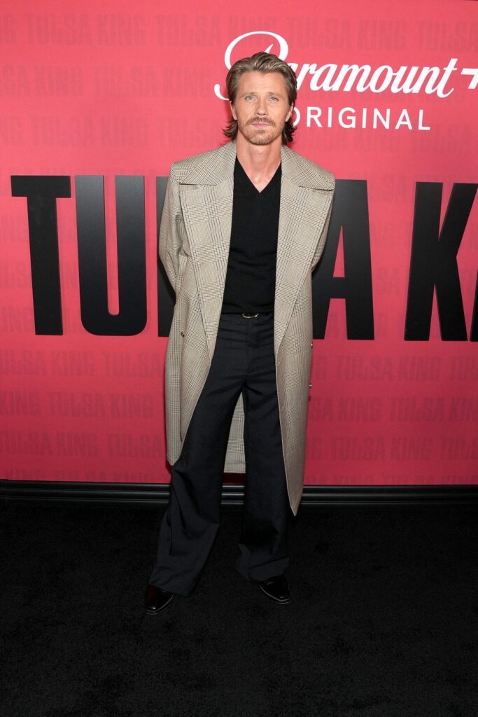 Garrett Hedlund attends the Tulsa King Panel, AMIRI coat,