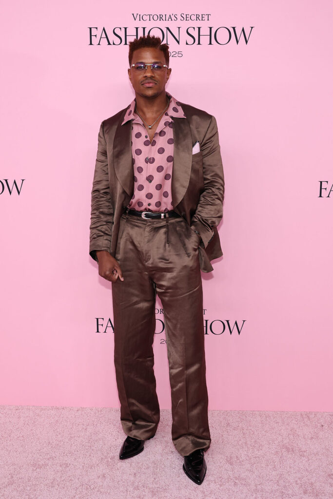 Jeremy Pope attends Victoria's Secret Fashion Show 2025, Todd Snyder Spring 2026, Victoria’s Secret Fashion Show 2025, mocha satin suit, La Buena Vida collection, pink flamenco dot shirt, menswear