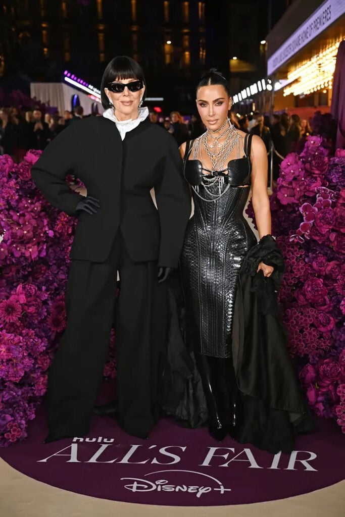 Kris Jenner, Jacquemus, Alaïa sunglasses, All’s Fair London premiere, black power suit, oversized tailoring, avant-garde fashion, minimalist style, celebrity red carpet, modern suiting, exaggerated shoulders, Lisa Rinna comparison, Edna Mode style, fashion critique, structured silhouette, fashion risk, press tour outfit, bold proportions, celebrity fashion moment, Hollywood style evolution