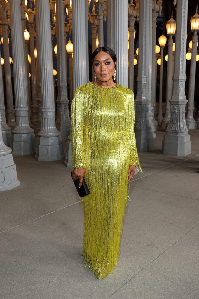 Angela Bassett, wearing Gucci, attends the 2025 LACMA Art+Film Gala, Angela Bassett Gucci yellow gold dress, Angela Bassett LACMA Art+Film Gala red carpet, Angela Bassett fringe gown, Angela Bassett Gucci look