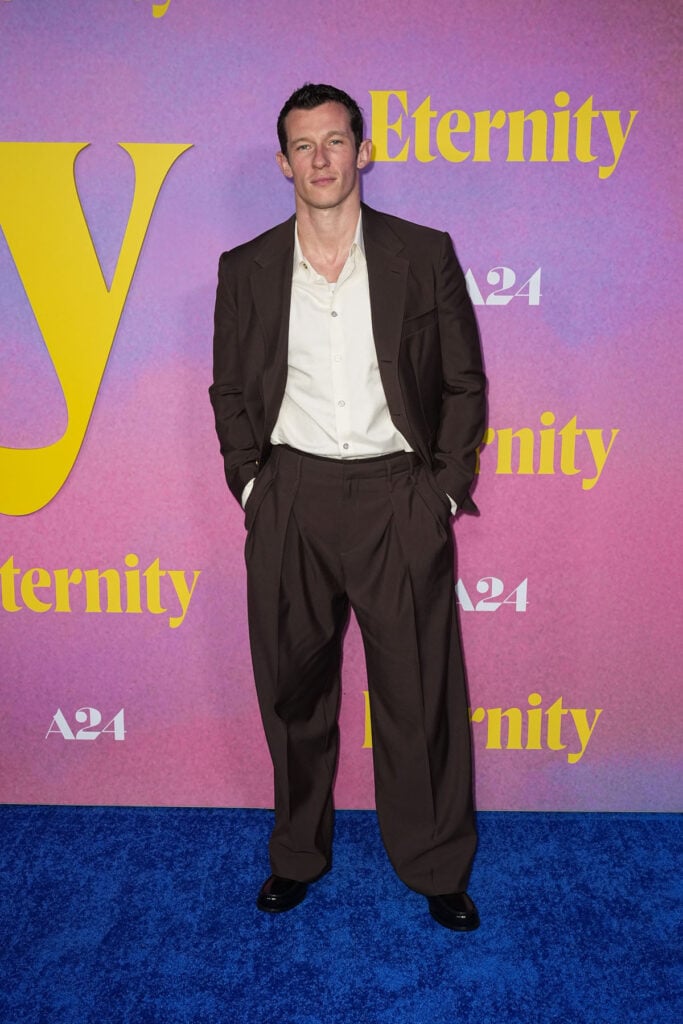 Callum Turner custom brown suit, brown single-breasted jacket menswear, Eternity New York Screening red carpet, Callum Turner pleated trousers, menswear 2025 red carpet, Louis Vuitton