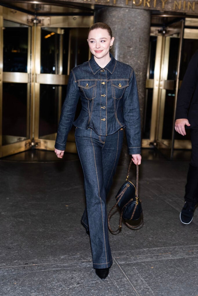 Chloë Grace Moretz Wore Louis Vuitton Promoting 'Oh. What. Fun' Chloë Grace Moretz, Chloe Grace Moretz Louis Vuitton, Louis Vuitton denim jacket, Louis Vuitton denim trousers, LV Legacy ankle boots, LV Express PM handbag, Oh What Fun promo, Chloe Grace Moretz street style 2025, New York celebrity style