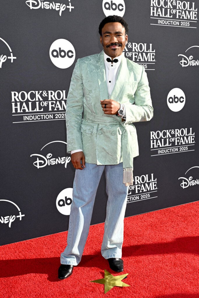 Donald Glover, aka Childish Gambino, at 2025 Rock & Roll Hall of Fame Induction Ceremony , Donald Glover Valentino Resort 2026, Valentino smoking jacket, frog-collar shirt red carpet, Rock & Roll Hall of Fame 2025 red carpet, menswear Valentino