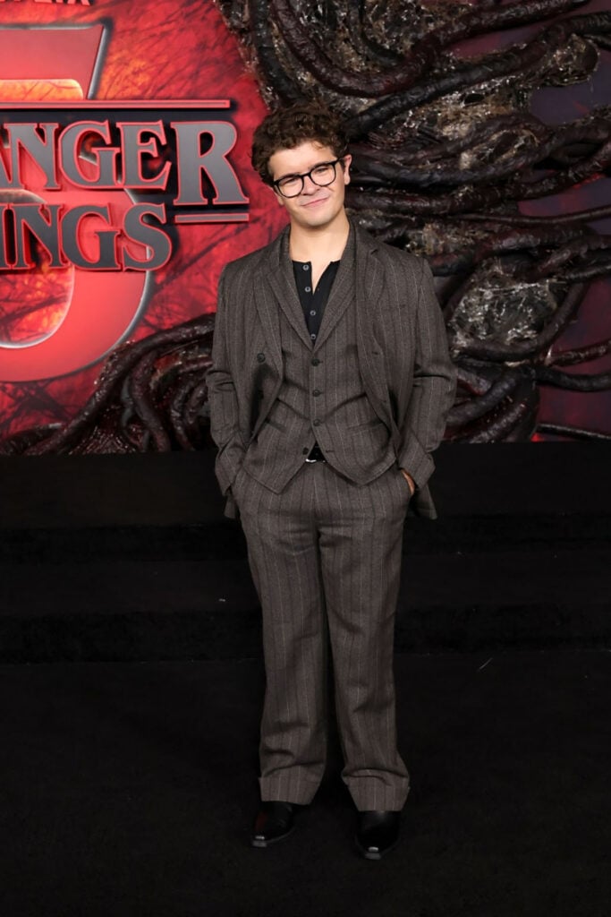 Gaten Matarazzo, Canali suit, Stranger Things Season 5 LA premiere red carpet, classic menswear moment, clean and timeless styling.