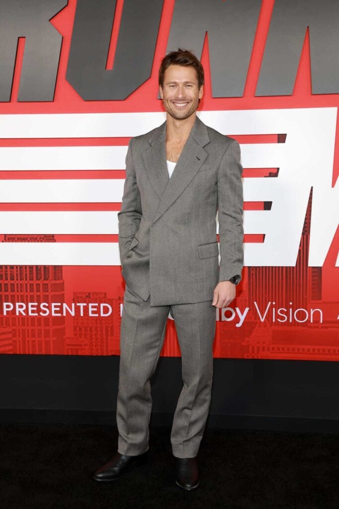 Glen Powell, The Running Man New York premiere red carpet, Emporio Armani suit, OMEGA watch, Glen Powell menswear, classic tailoring red carpet