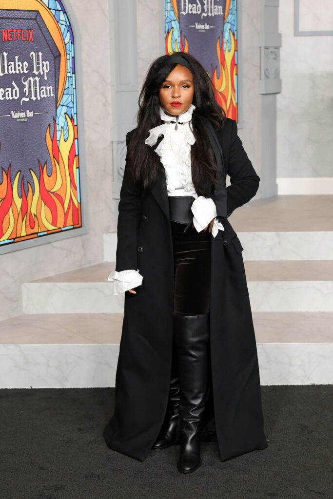 Janelle Monáe Wake Up Dead Man LA premiere red carpet, Janelle Monáe black coat look, neo-Victorian red carpet outfit, romantic ruffled blouse, Sheryl Lowe Jewelry, Knives Out Mystery premiere fashion