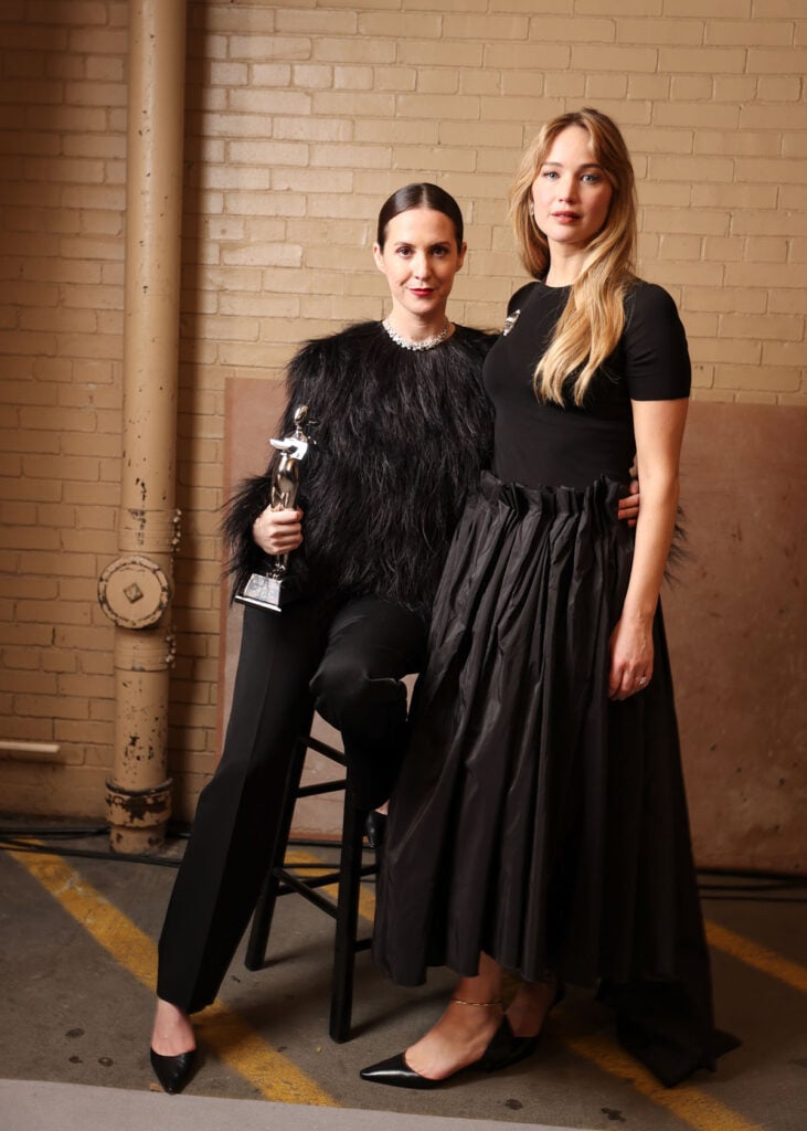 Jennifer Lawrence 2025 CFDA Fashion Awards The Row, Jennifer Lawrence, The Row Spring 2026, black feather top, paper bag waist skirt, Belperron brooch, CFDA Fashion Awards red carpet, Ryan Hastings styling, Die My Love press tour.