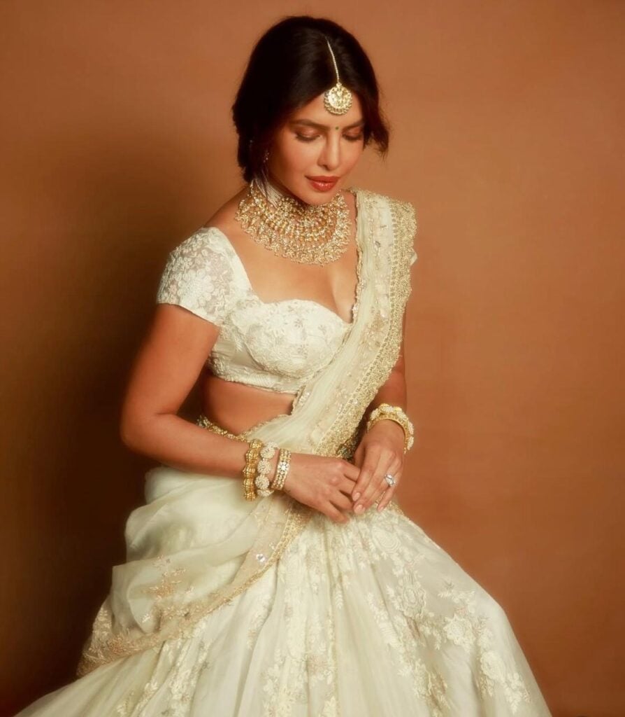 Priyanka Chopra Wore Anamika Khanna Promoting 'Varanasi' Priyanka Chopra, Varanasi event, Ramoji Film City Hyderabad, Anamika Khanna, white lehenga, pavadai thavani drape, Telugu speech, Indian traditional dress, Priyanka Chopra traditional look, Varanasi film promo