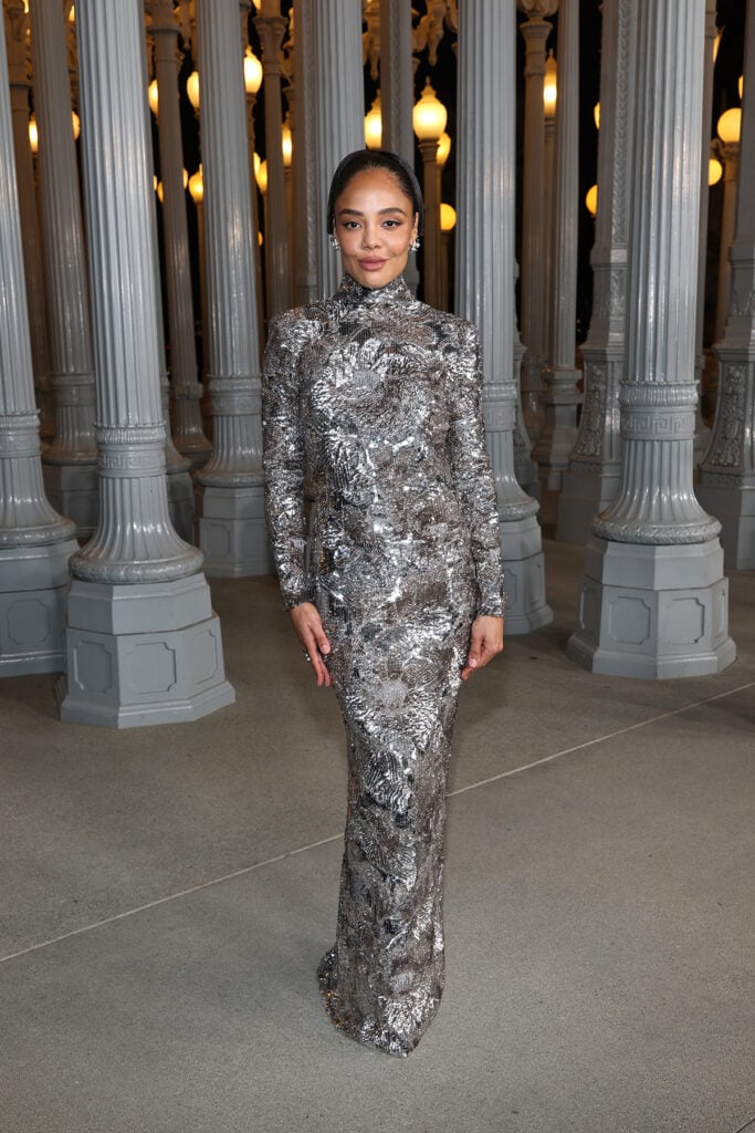 Tessa Thompson, wearing Gucci, attends the 2025 LACMA Art+Film Gala, Tessa Thompson Gucci silver dress, Tessa Thompson LACMA Art+Film Gala red carpet, Tessa Thompson open back gown, Tessa Thompson sequined long sleeve dress