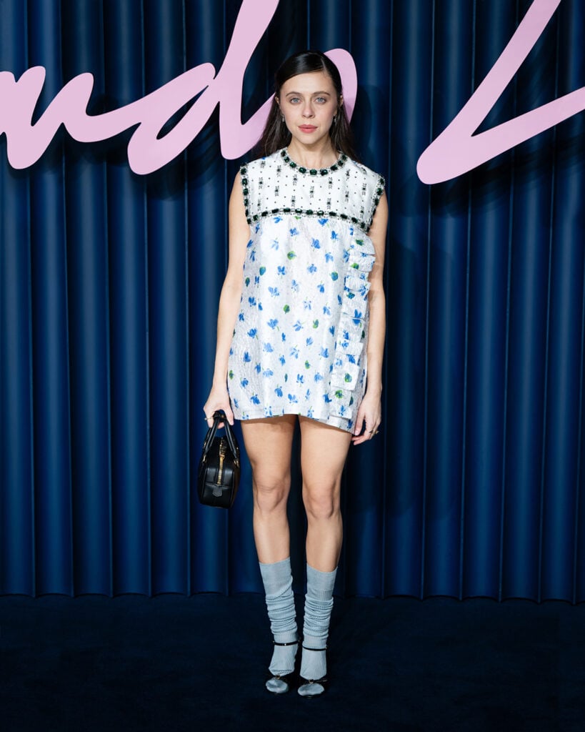 Bel Powley Miu Miu Spring 2026, Miu Miu Spring 2026 white cloqué dress, Bel Powley The Fashion Awards 2025 red carpet, Miu Miu Arcadie bag, Bel Powley style