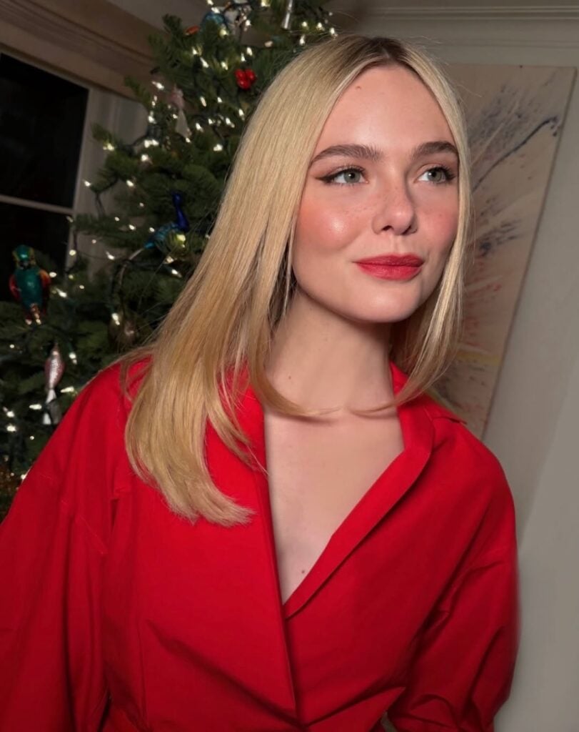 Elle Fanning Wore Ralph Lauren To The Neon Holiday Party, Elle Fanning, Neon Holiday Party red carpet, Elle Fanning Ralph Lauren, Ralph Lauren Collection red dress, holiday red carpet fashion, awards season style, celebrity holiday party looks, Cartier jewellery