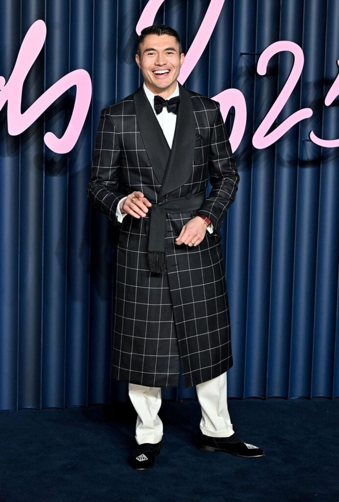 Henry Golding at The Fashion Awards 2025, Henry Golding, dunhill Spring 2026, dunhill menswear, windowpane check coat, AD Cypher velvet slippers, Cartier Tank Louis watch, London red carpet menswear, The Fashion Awards 2025 menswear, The Fashion Awards 2025 red carpet, modern red-carpet tailoring.