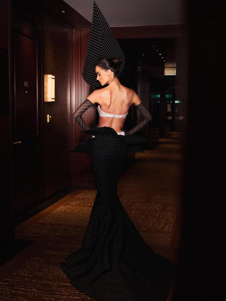 Maura Higgins Wore Robert Wun Couture To The Fashion Awards 2025, Maura Higgins, Robert Wun Fall 2025 Couture, The Fashion Awards 2025 red carpet, Robert Wun Couture, deconstructed pinstripe gown, tuxedo bag, avant-garde red carpet, London Fashion Awards