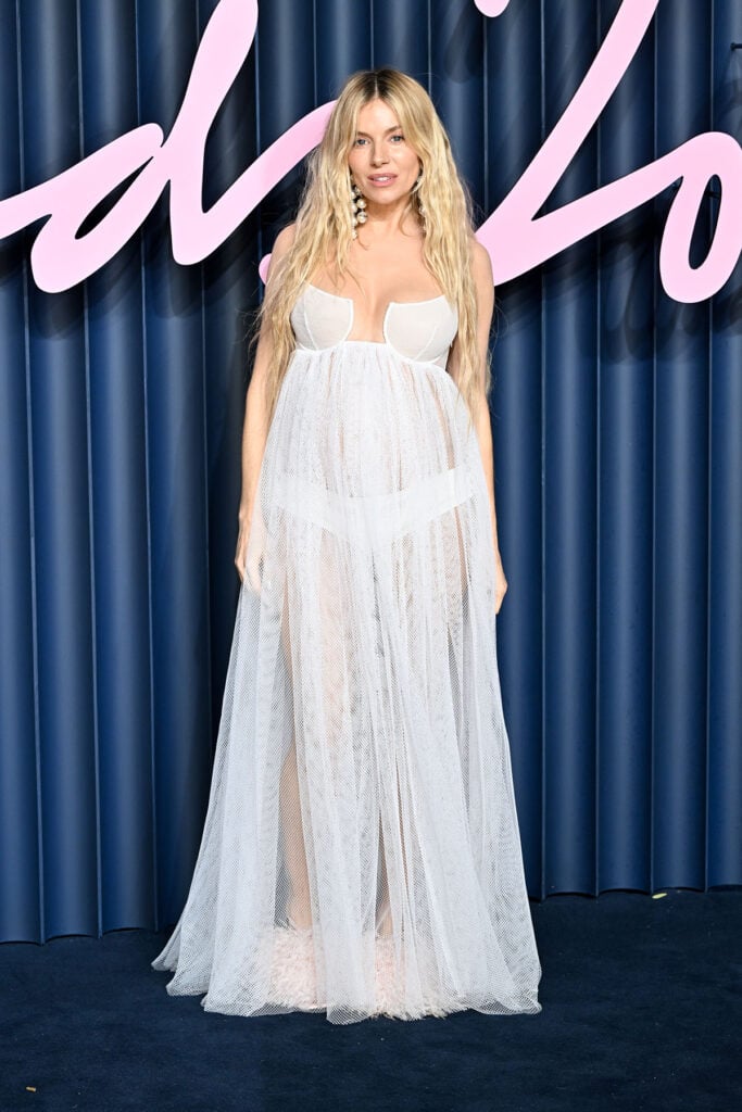 Sienna Miller at The Fashion Awards 2025, Sienna Miller, Givenchy Spring 2026, Givenchy Spring 2026 white cutaway empire dress, Givenchy Boudoir feather sandals, The Fashion Awards 2025 red carpet, Sienna Miller Givenchy 2025, Sienna Miller maternity style, Sarah Burton Givenchy