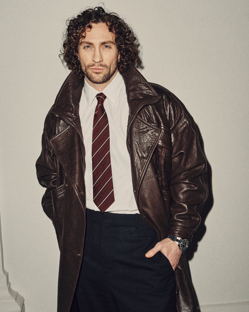 Aaron Taylor-Johnson, Saint Laurent front row, Paris Fashion Week, Saint Laurent Fall 2026 menswear, black tailoring, menswear street style, actor fashion