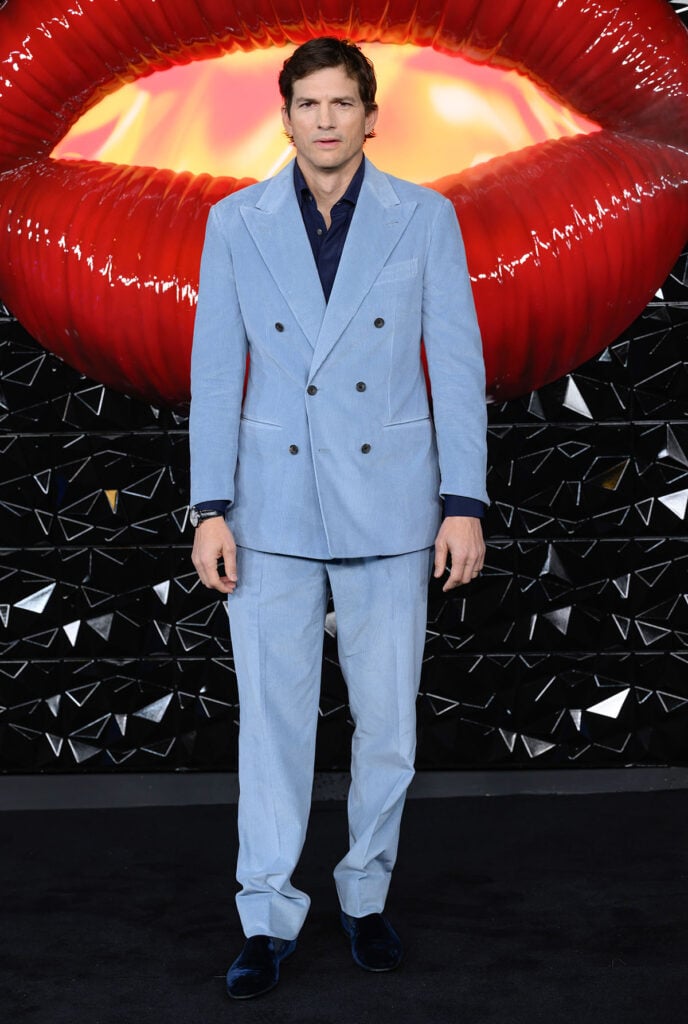 Ashton Kutcher, The Beauty London premiere, Ashton Kutcher red carpet, Thom Browne corduroy suit, blue corduroy suit, Manolo Blahnik velvet slippers, OMEGA timepiece