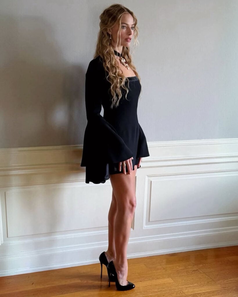 Margot Robbie, Margot Robbie method dressing, Wuthering Heights method dressing, Margot Robbie Wuthering Heights press tour, Margot Robbie press junket, Roberto Cavalli Resort 2026, black mini dress, Andrew Mukamal