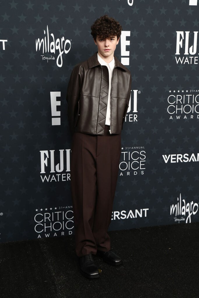Owen Cooper, Bottega Veneta custom look, Owen Cooper red carpet, 2026 Critics’ Choice Awards menswear, brown leather jacket, Intrecciato collar, Bottega Veneta leather jacket, Aimée Croysdill styling