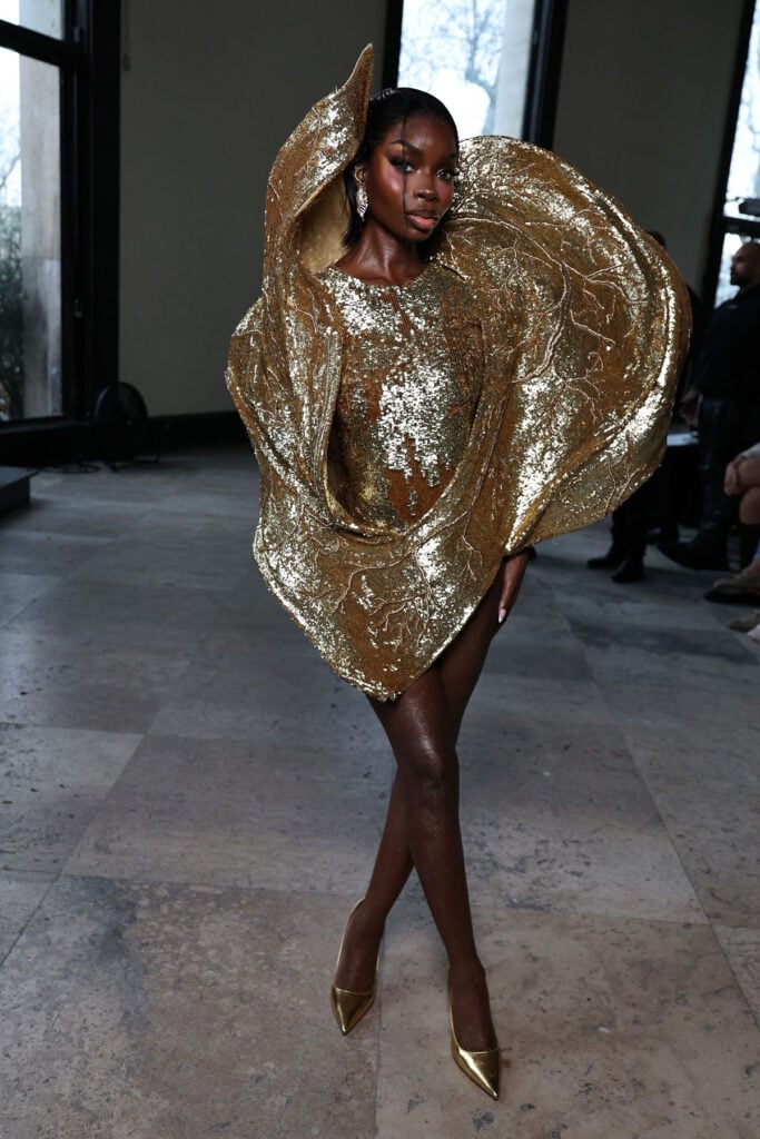 Olandria Carthen Makes Her Front Row Debut At Rahul Mishra , Olandria Carthen, Rahul Mishra Spring 2026 Couture, Rahul Mishra couture show, Paris Haute Couture Fashion Week front row, sculptural couture dress, gold couture look, Rahul Mishra front row, Olandria Carthen fashion, couture front row style