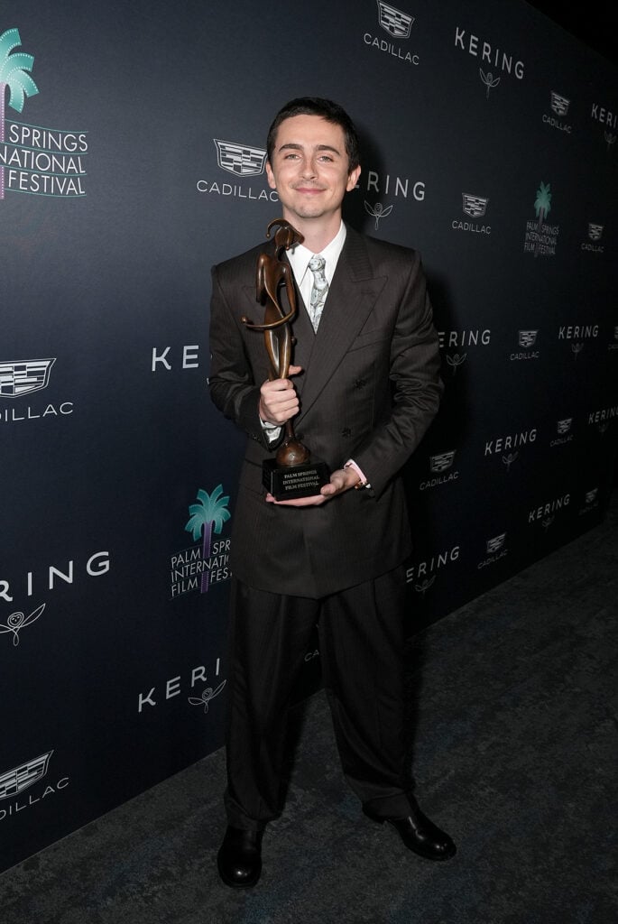 Timothée Chalamet, Timothée Chalamet red carpet, Palm Springs International Film Awards menswear, Givenchy by Sarah Burton suit, archival silk tie, Timothée Chalamet style evolution, awards season menswear