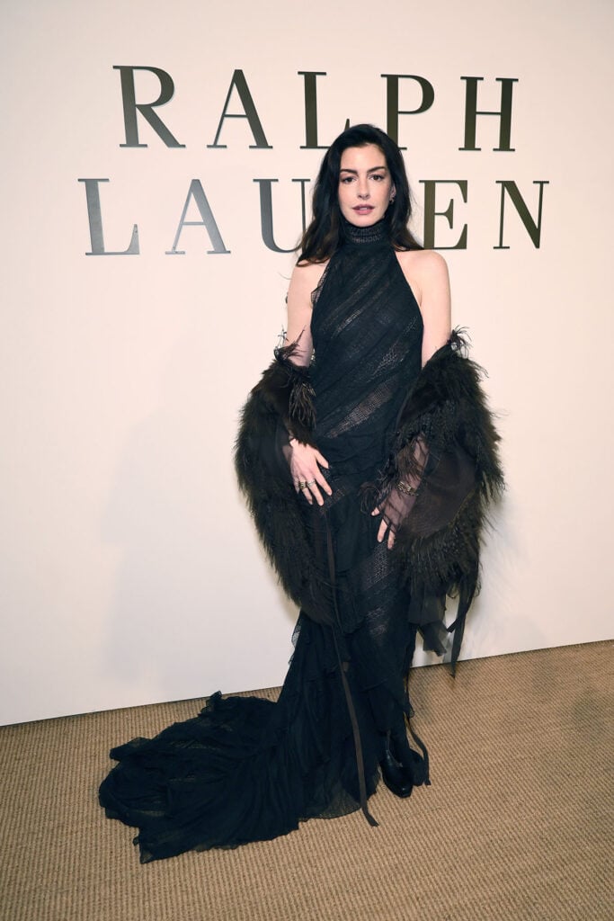 Anne Hathaway Front Row At The Ralph Lauren Collection Fall 2026 Show, Anne Hathaway, Ralph Lauren Fall 2026, Ralph Lauren Women’s Collection Fall 2026, Anne Hathaway Ralph Lauren, New York runway show, Ralph Lauren eveningwear, Anne Hathaway black gown, celebrity front row style