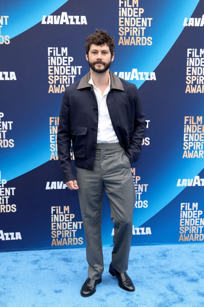Dylan O’Brien, Dior Fall 2026, Dior navy jacket, leather collar blazer, contemporary mens tailoring, Film Independent Spirit Awards 2026, relaxed red carpet suit