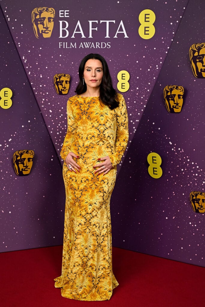 Jessie Ware, Etro velvet open-back gown, Jessie Ware BAFTAs 2026, golden velvet evening dress, Bvlgari jewellery red carpet, BAFTA Film Awards London style
