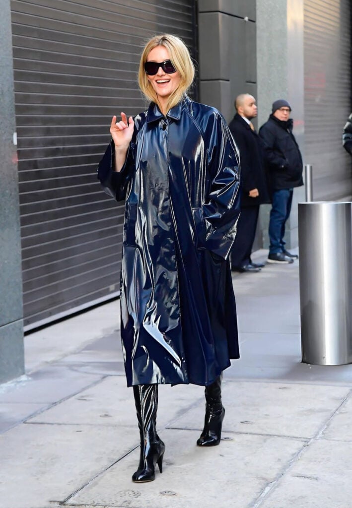 Sarah Pidgeon is seen outside "ABC Studio"  Sarah Pidgeon, Love Story John F Kennedy Jr and Carolyn Bessette, Adam Lippes Merriam coat, Lanvin wool trench, Khaite Pre-Fall 2026 leather halter dress, Aflalo Affine leather coat, Le Monde Béryl boots, Jimmy Fairly sunglasses, New York press tour style, winter outerwear fashion