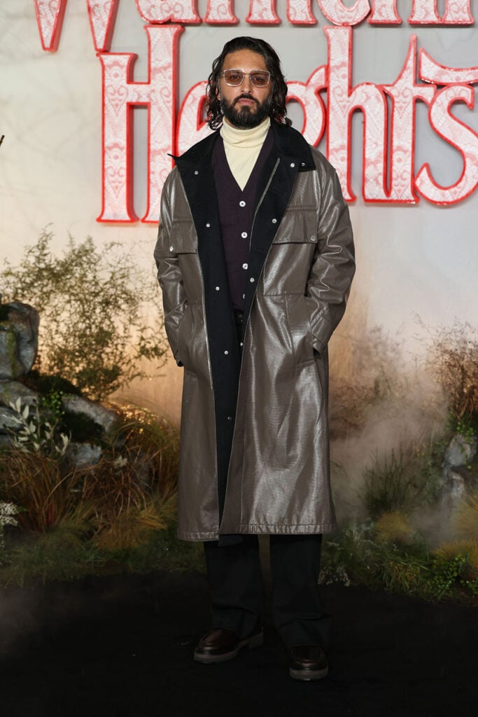 Shazad Latif, Shazad Latif HermĆØs, HermĆØs menswear, Shazad Latif Wuthering Heights London premiere, Wuthering Heights London premiere menswear, Odeon Luxe Leicester Square, yellow turtleneck menswear, shimmering coat menswear, rain ready red carpet look, London premiere style