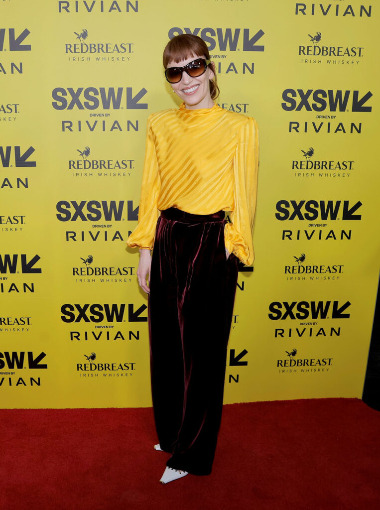 Britt Lower SXSW Film Festival 2026 Valentino, Britt Lower Sender premiere SXSW 2026, SXSW 2026 red carpet Britt Lower yellow top burgundy trousers, SXSW Film Festival Austin red carpet Britt Lower style, Valentino Pre-Fall 2026 Britt Lower SXSW premiere, Britt Lower yellow top burgundy velvet trousers Valentino SXSW
