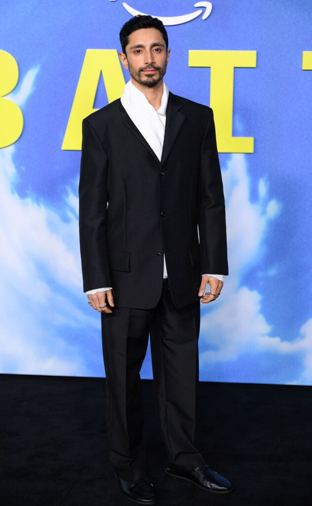 Riz Ahmed attends the "Bait" London premiere at Shoreditch Electric, Riz Ahmed Bait London premiere, Riz Ahmed Bait red carpet, Bait London premiere menswear style, Bottega Veneta Riz Ahmed suit, Riz Ahmed parachute shirt Bottega Veneta, Bottega Veneta Dawson lace-up shoes Riz Ahmed, London premiere red carpet menswear, Riz Ahmed tailoring style