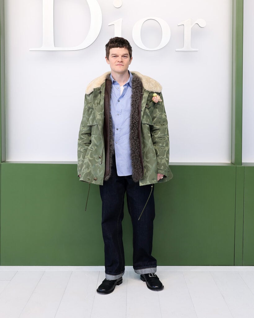 Robert Aramayo Dior Fall 2026 show, Robert Aramayo Dior front row, Robert Aramayo Dior field coat look, Robert Aramayo Dior Paris Fashion Week, Dior Fall 2026 Robert Aramayo