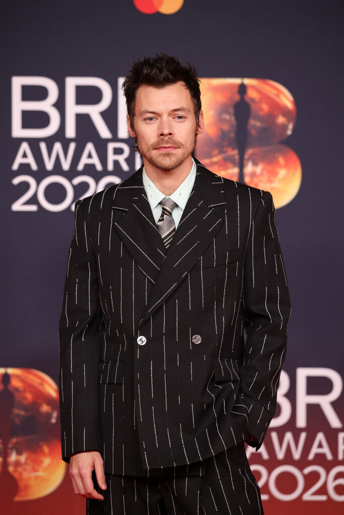 Harry Styles, BRIT Awards 2026, Harry Styles Chanel Pre-Fall 2026, Chanel Pre-Fall 2026 menswear, Harry Styles pinstripe suit, Harry Styles BRIT Awards red carpet, Chanel bouclé suit, Harry Styles performance look, BRIT Awards fashion 2026