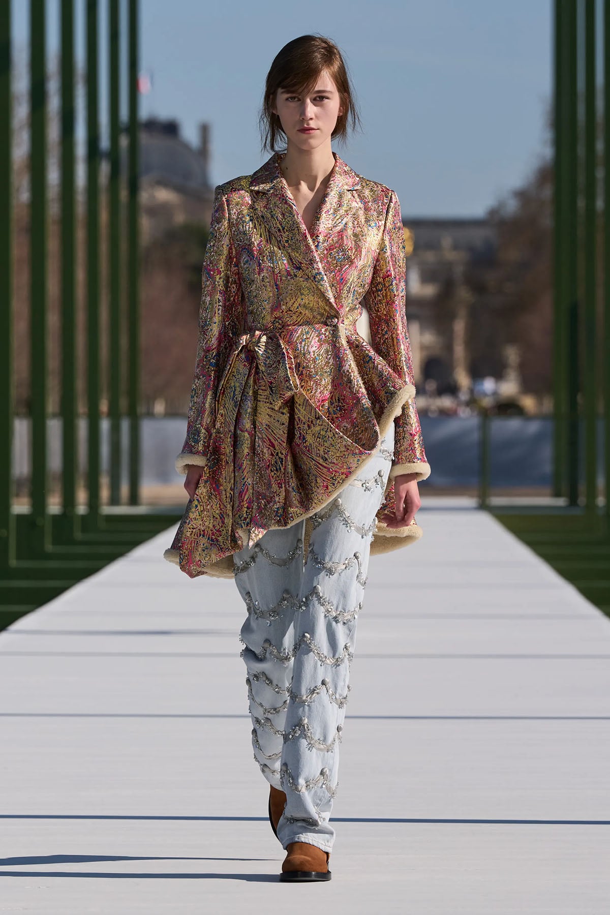 Dior Fall 2026 brocade jacket styled with embellished jeans on the runway.