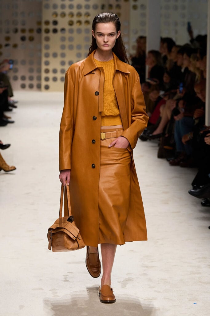 Tod’s marigold leather trench coat from the Spring 2026 runway collection