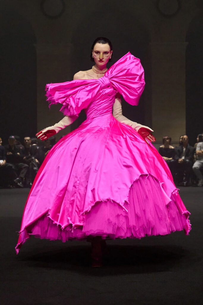 Matières Fécales Fall 2026 pink couture gown with oversized bow detail and voluminous skirt on the runway.