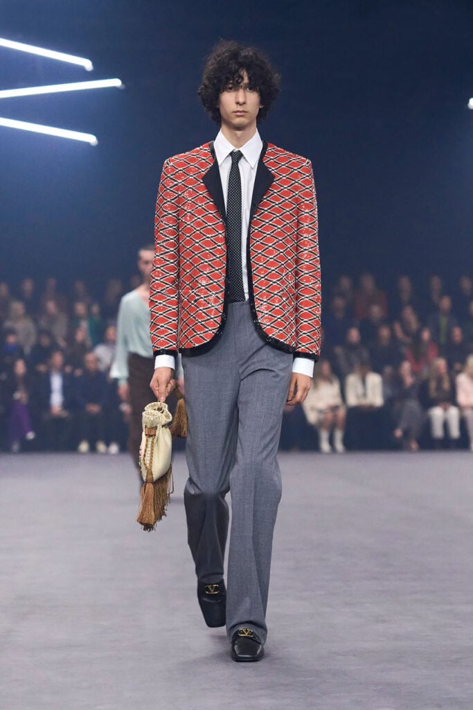 Runway look from the Valentino Spring 2026 collection featuring a sequinned jacket and tie styling
