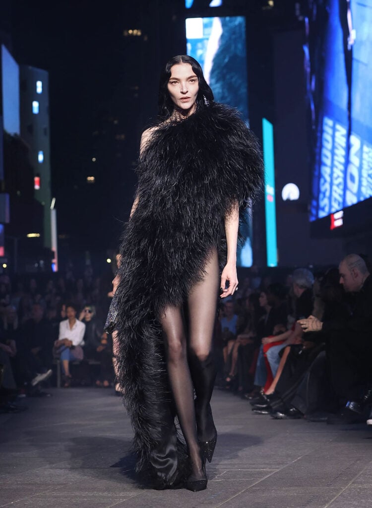 A model walked the Gucci Resort 2027 runway in the feathered asymmetrical look later worn by Demi Moore at Cannes.