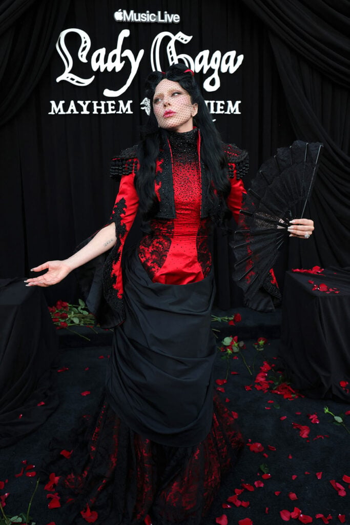Lady Gaga in red and black Givenchy Haute Couture during the MAYHEM Requiem procession at The Grove in Los Angeles
