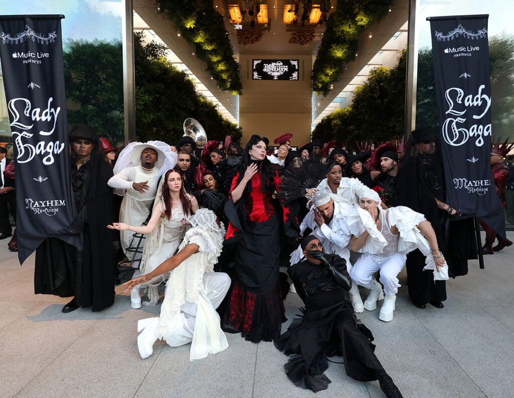 Lady Gaga surrounded by performers during the Apple Music MAYHEM Requiem activation in Los Angeles

