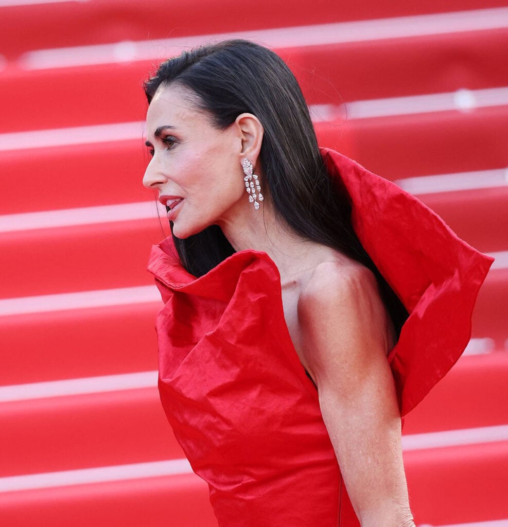 Red Gucci gown by Demna with sculptural neckline at the Fatherland Cannes premiere
