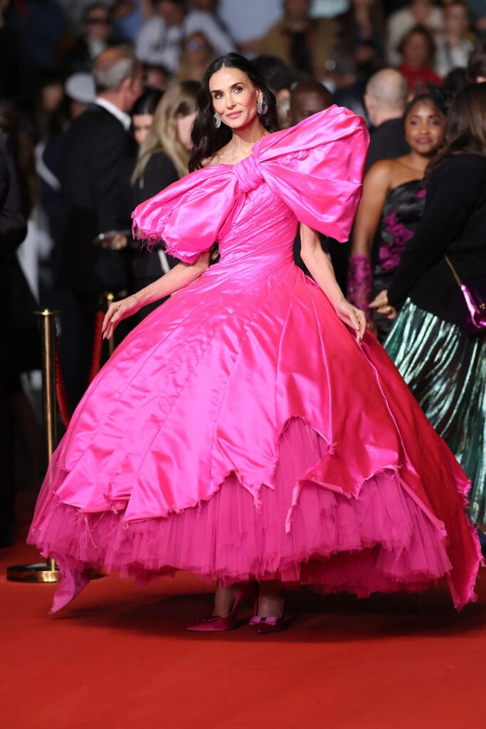 Demi Moore posed on the Cannes red carpet wearing a sculptural pink Matières Fécales couture gown for the ‘Paper Tiger’ premiere.