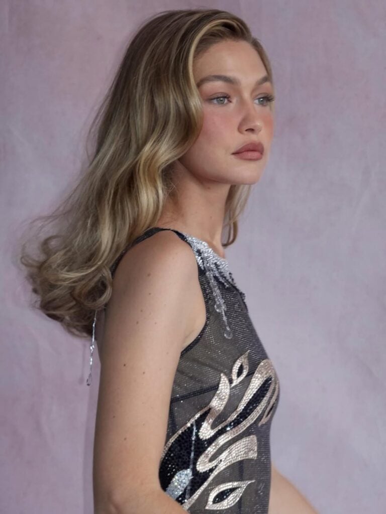 Side profile of Gigi Hadid showcasing radiant skin and blush-forward makeup at the Met Gala in New York.
