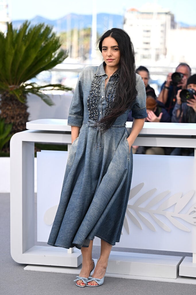 Hafsia Herzi wore a denim Dior dress to the Quelques Mots D'Amour photocall in Cannes.