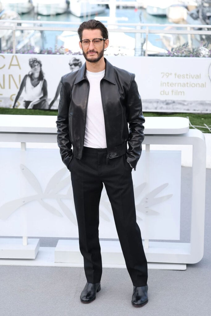 Pierre Niney wore a black Balenciaga leather jacket with tailored trousers to the Histoires Parallèles photocall at Cannes Film Festival.