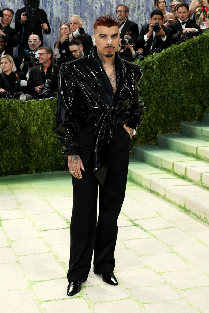 Rauw Alejandro in glossy black Saint Laurent shirt and tailored trousers, Met Gala 2026