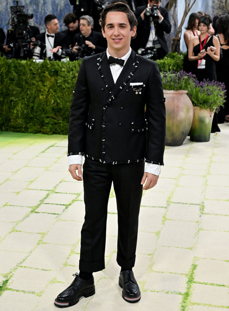 Marcello Hernandez in Thom Browne at the 2026 Met Gala wearing a classic black tuxedo with white shirt and bow tie
